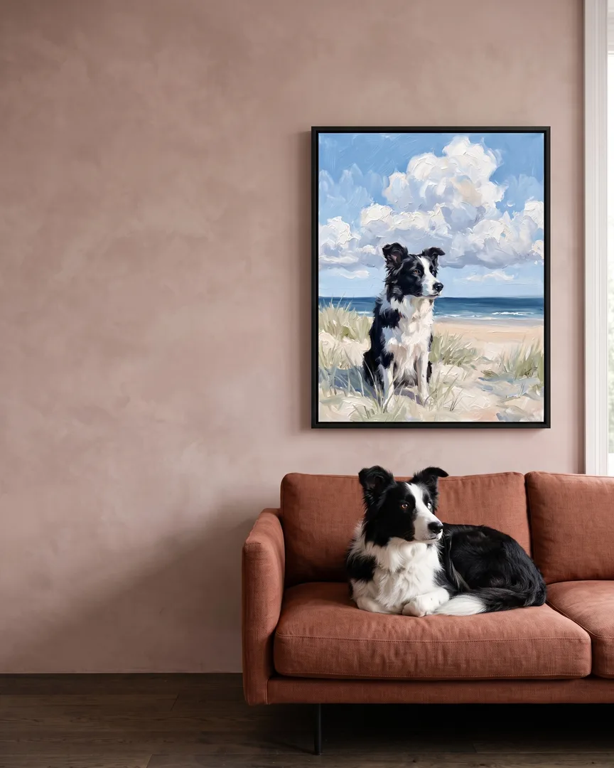Skye, a border collie, beside a black framed canvas of their own Windswept Dunes portrait.
