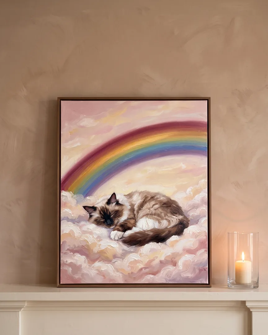 A brown framed canvas of Willow, a Ragdoll, a Gentle Skies portrait, on a mantel beside a lit candle.