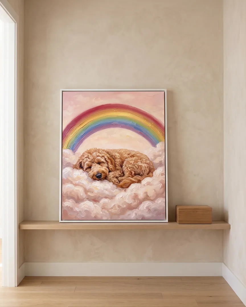 A white framed canvas of Teddy, a goldendoodle, a Gentle Skies portrait, on a hallway shelf beside a keepsake box.