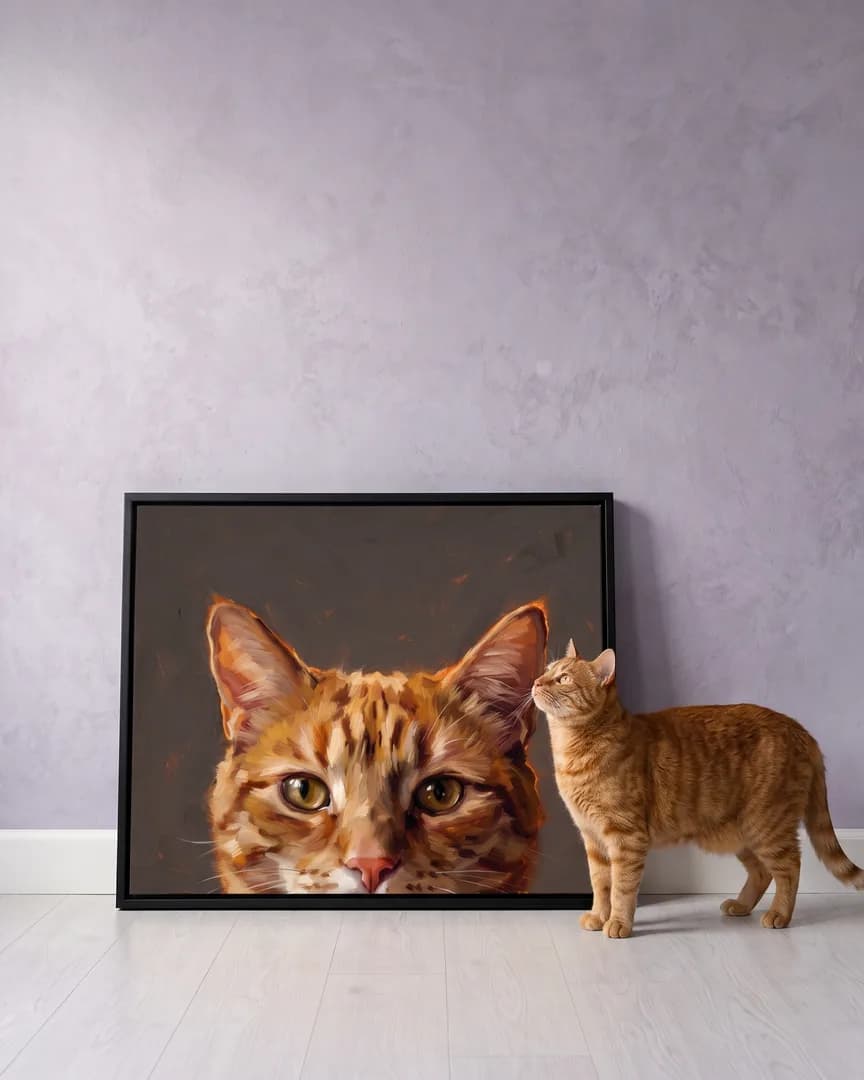 Miel, an orange tabby cat, beside a black framed canvas of their own Painted Peek portrait.