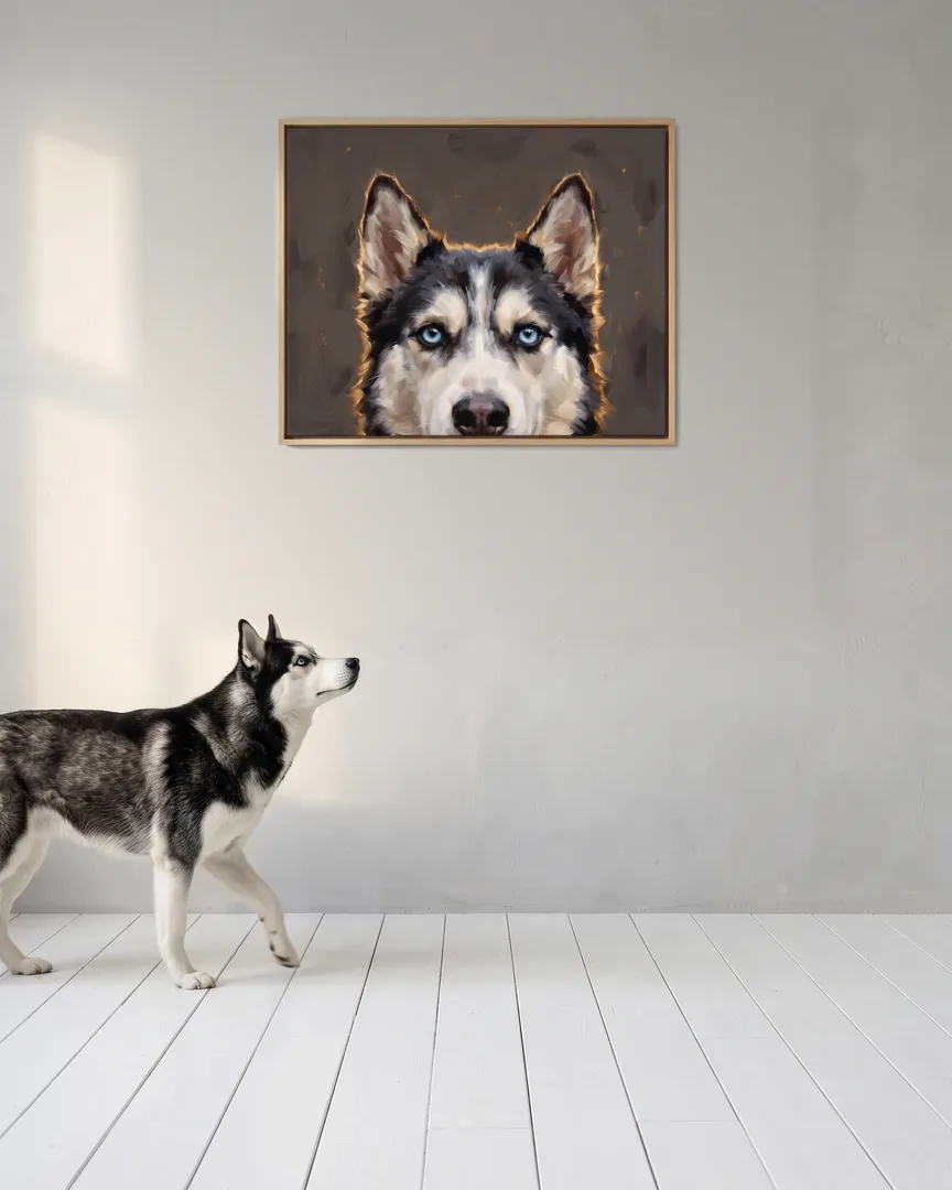 Nova, a Siberian husky, beside a natural-oak framed canvas of their own Painted Peek portrait.