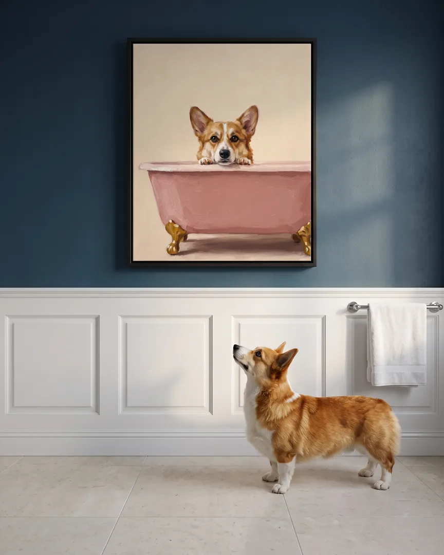 Pixel, a Pembroke Welsh corgi, beside a black framed canvas of their own Powder Pink Bath portrait.