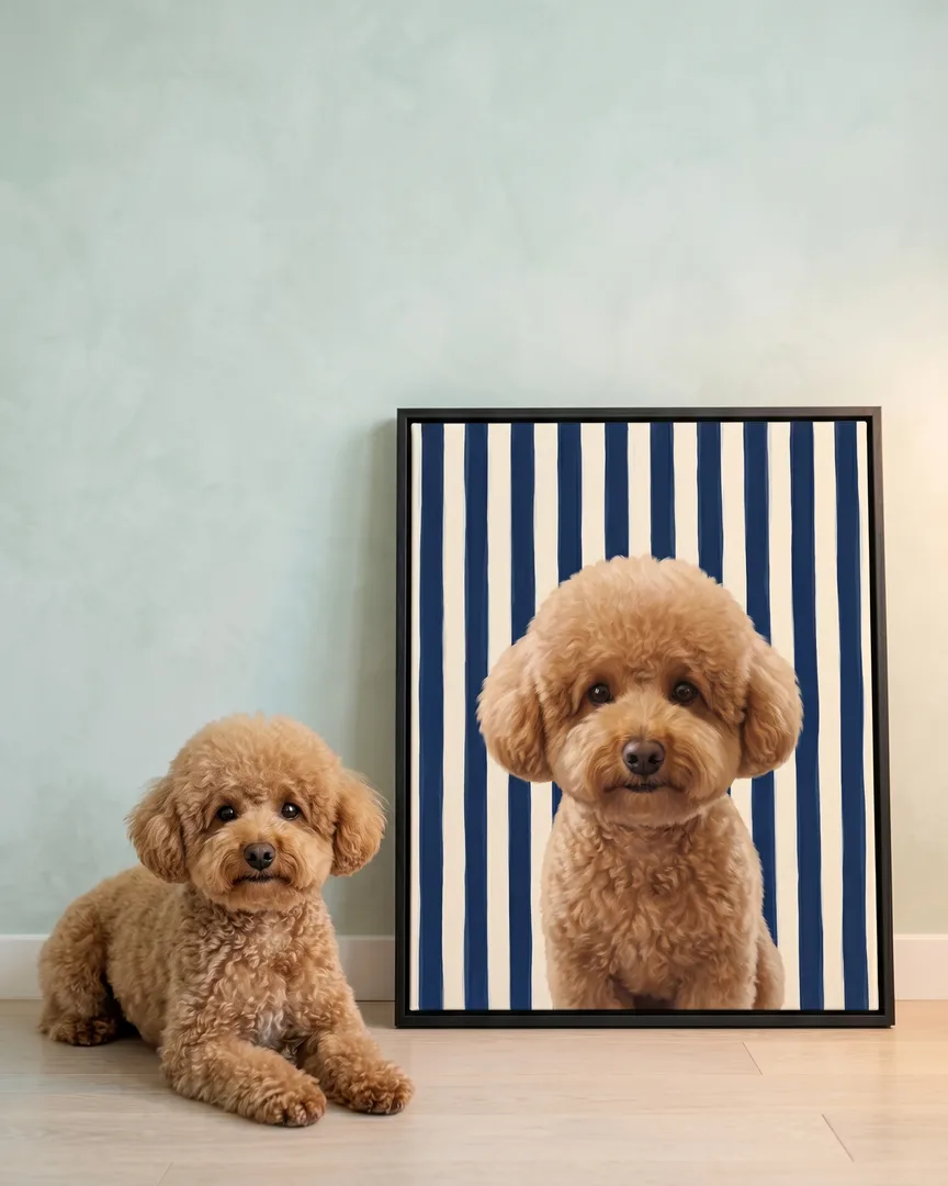Mimi, a toy poodle, beside a black framed canvas of their own Riviera Stripe portrait.
