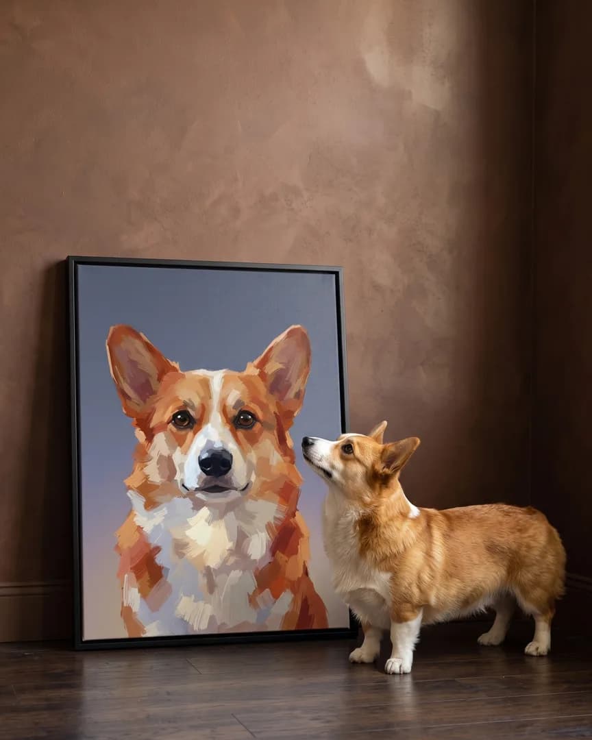 Pixel, un corgi, à côté d'une toile encadrée noire de son portrait Portrait ardoise.
