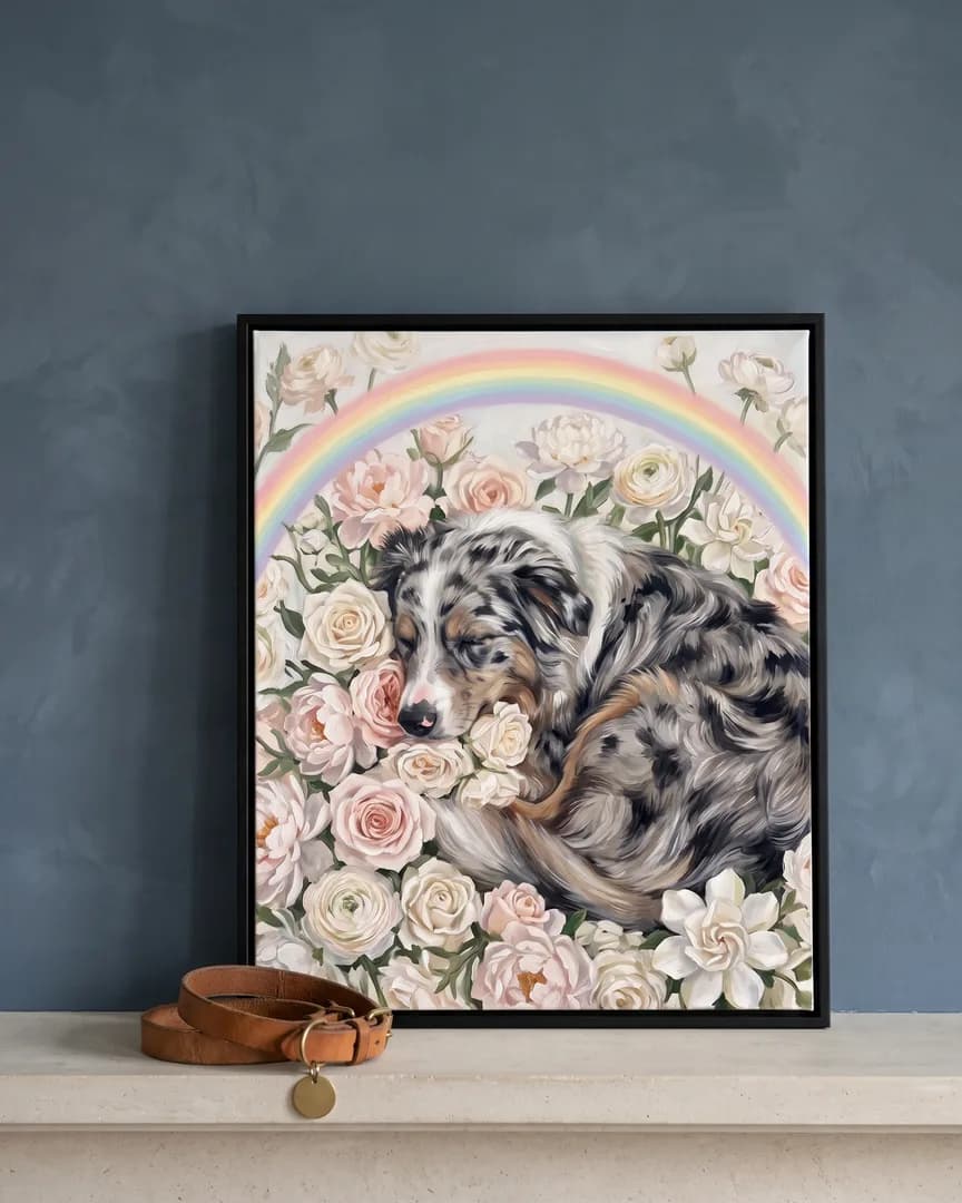 A black framed canvas of Koda, an Australian shepherd, a White Roses portrait, on a limestone mantel beside a collar.