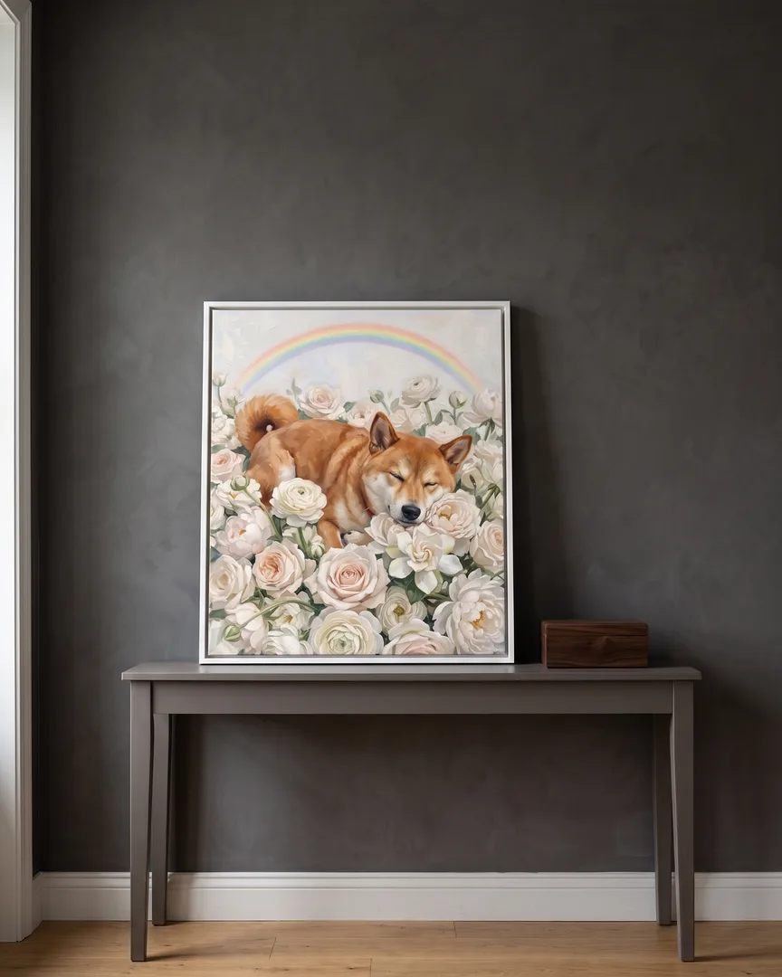 A white framed canvas of Suki, a Shiba Inu, a White Roses portrait, on a console table beside a keepsake box.