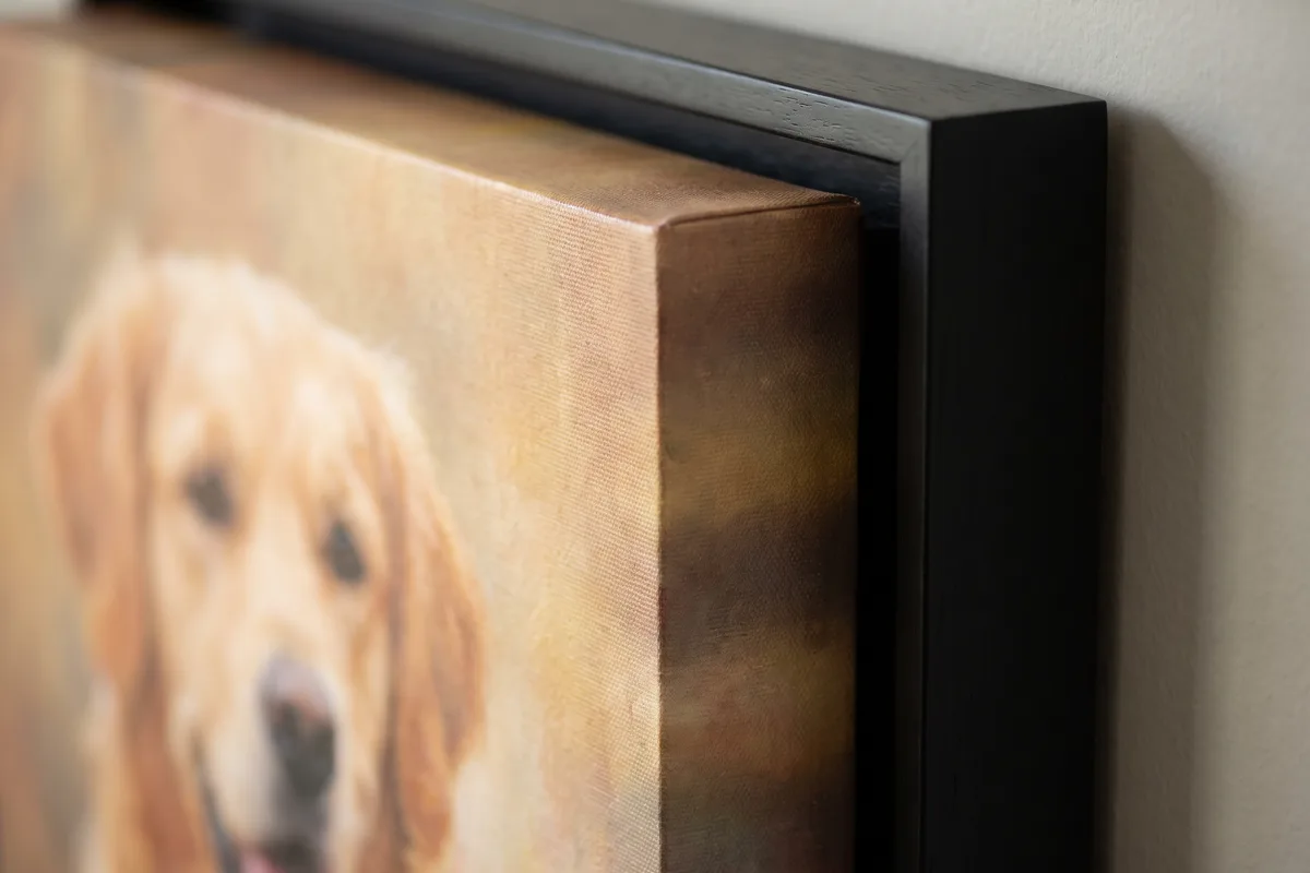 A macro view of the open gap between a canvas edge and the black float frame around it, with shadow falling into the gap